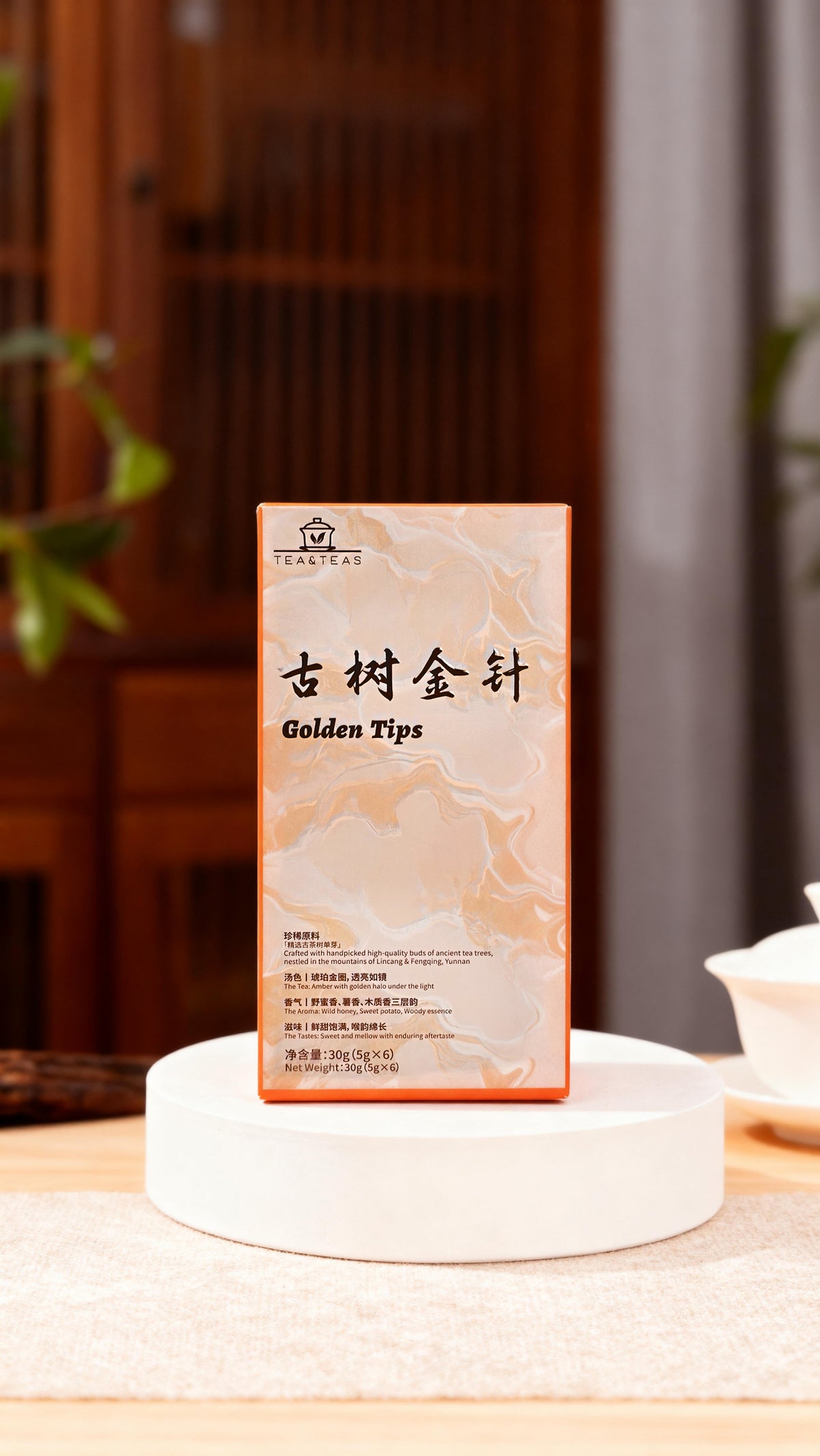 Tea packaging labeled 'Golden Tips' on a white stand with a blurred background