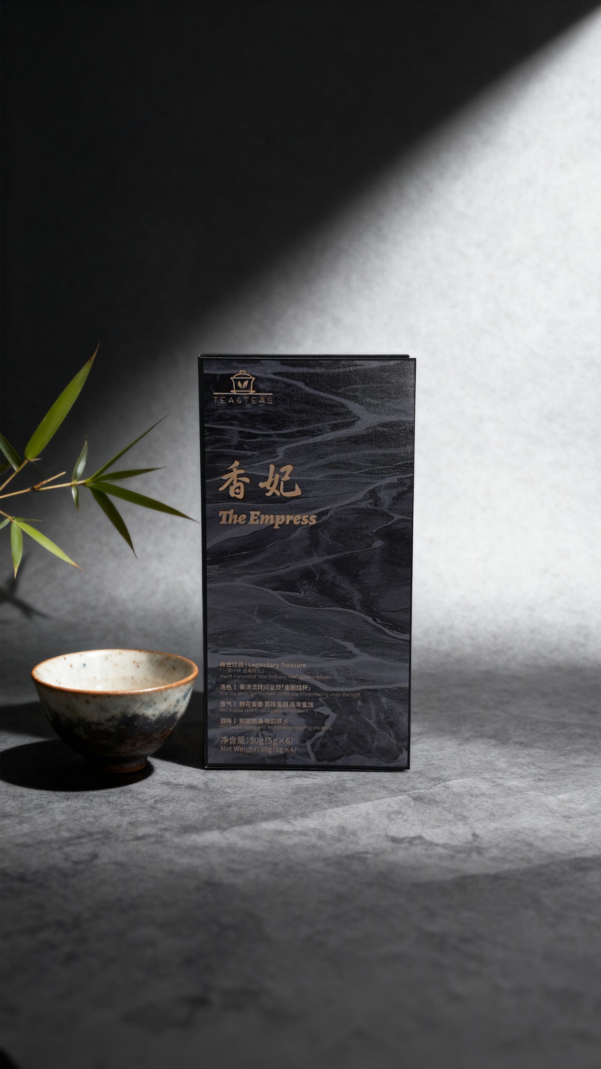 Tea packaging labeled 'The Empress' on a white stand with a blurred background