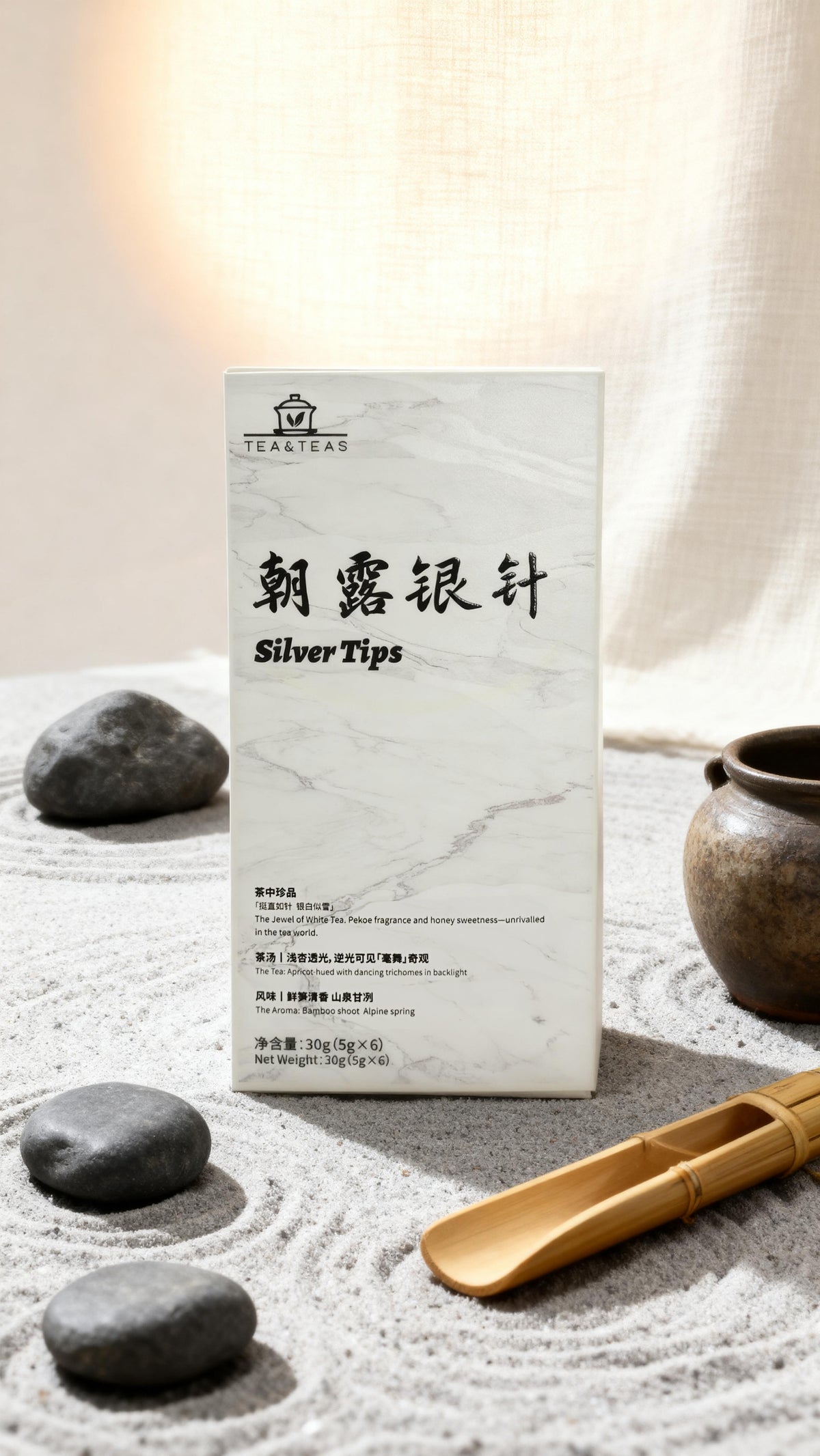 Tea packaging with 'Silver Tips' text on a stone and tea pot background.